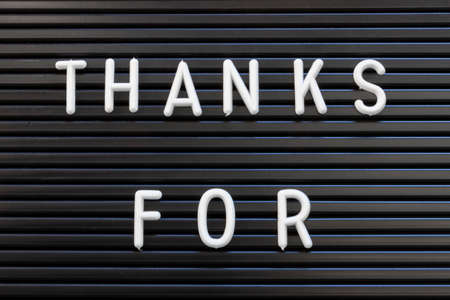 Thanks For in white text on a black striped background for thanking and appreciation.の写真素材