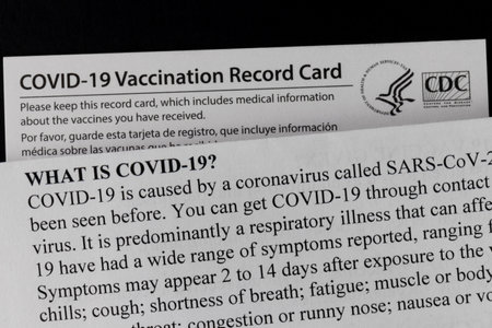 Indianapolis - Circa February 2021: COVID-19 Vaccination Record Card with COVID information. Vaccination Record Cards will be offered with each vaccination and a reminder for the second dose.のeditorial素材