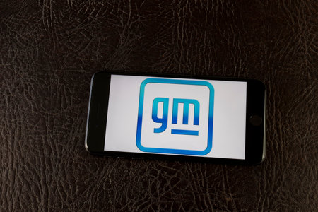 Indianapolis - Circa February 2021: General Motors new logo on a smartphone. GM is promoting the new symbol with the goal of selling only Zero-Emission vehicles by 2035.のeditorial素材