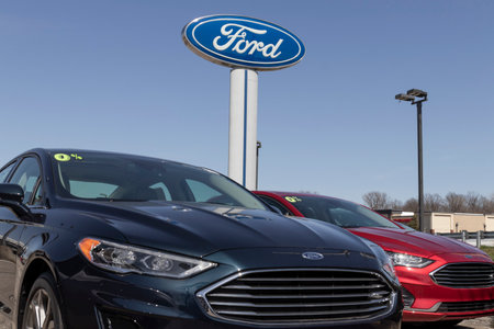 Fishers - Circa March 2021: Ford Fusion display at a dealership. Ford sells traditional gasoline, electric and hybrid SUV models.のeditorial素材