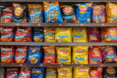 Cincinnati - Circa September 2021: Frito Lay potato and snack chip display. Frito-Lay is a subsidiary of PepsiCo and manufactures chips and other salty snacks.のeditorial素材
