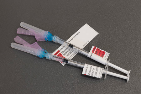 Indianapolis - Circa November 2021: Moderna COVID-19 Vaccination booster syringes or hypodermic needles. COVID-19 boosters have been recommended for all adults.のeditorial素材