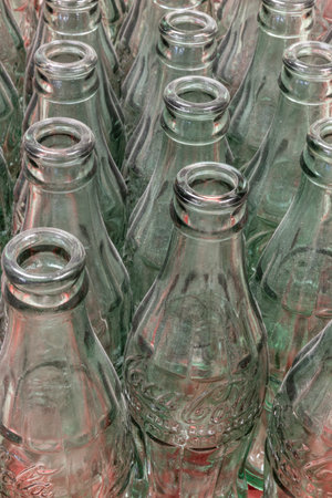 Indianapolis - Circa November 2021: Traditional Coke bottles in a row. Coca Cola has been using the patented Coke-Bottle since 1915.のeditorial素材