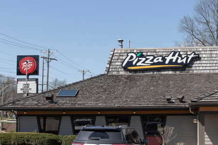 Logansport - Circa April 2022: Pizza Hut restaurant. Pizza Hut is offering delivery, Carry Out and...
