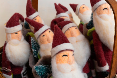 Santa Claus in a basket as a Christmas decoration. Happy Santas waiting for new homes at Christmastime.の写真素材