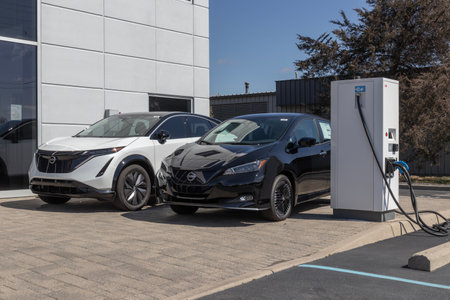 Indianapolis - Circa March 2023: Nissan Leaf and Ariya display at a dealership. Nissan offers the Leaf and Ariya EV Electric Vehicles for a clean environment.のeditorial素材
