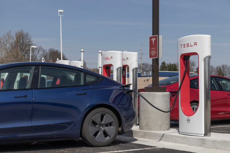 Lafayette - Circa April 2023: Tesla EV electric vehicle charging. Tesla products include electric...