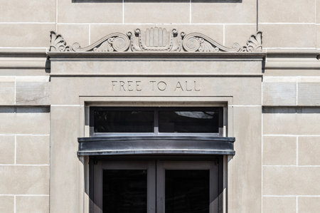 FREE TO ALL text in sandstone library building facade.の写真素材