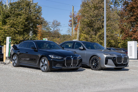 Indianapolis - October 20, 2024: BMW i4 and i7 at an electric vehicle charger at a dealership. BMW offers gas, EV, Hybrids and Plug-In Hybrid vehicles.のeditorial素材