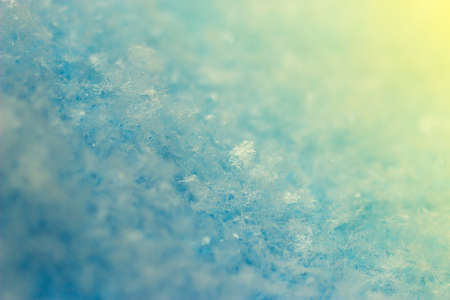Macro image of the snow surface on sunset. Winter background.の写真素材