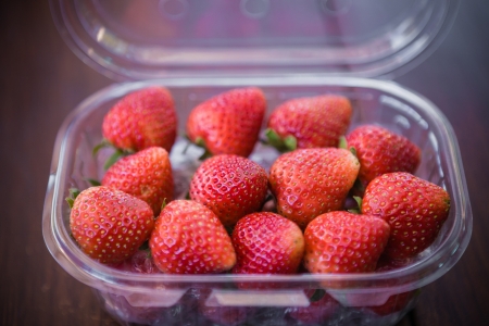 strawberries in plastic packingの写真素材