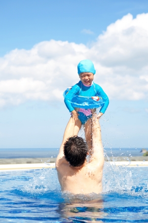 Father and Daughter  playing in swimming Poolの写真素材