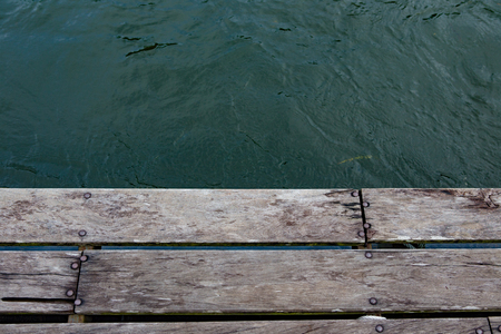 wood jetty floor on running riverの写真素材