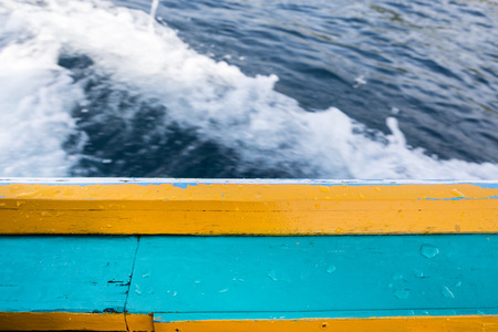 long tail boat gunnel with wet drop water on blurred waving backgroundの写真素材