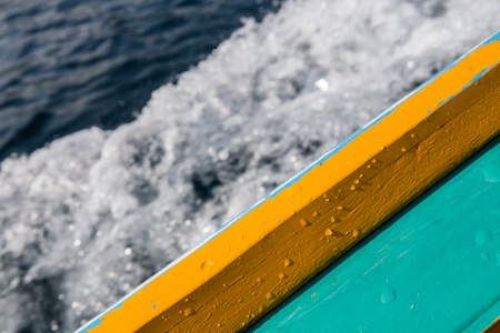 long tail boat gunnel with wet drop water on blurred waving backgroundの写真素材