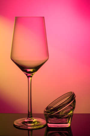 Wineglass for white wine on a red-yellow colored backgroundの写真素材