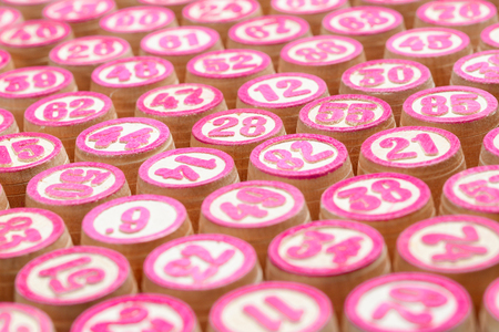 Board game lotto or bingo. Wooden lotto barrels with numbers, close-up. Vintage Game.の写真素材