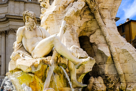 The figure of the Ganges River with a paddle in his hand, a fragment of the Fountain of Four Rivers, Piazza Navona, Rome, Italy.の写真素材