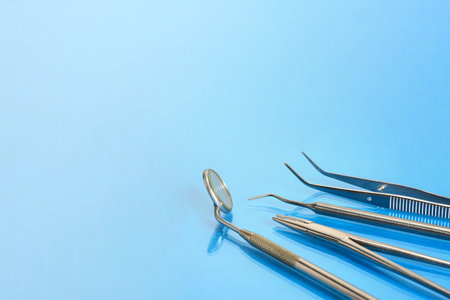 Dental basic tools on blue glass table in dentists offfice: dental mirror, kornzange, explorer,...