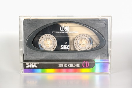 PRAGUE, CZECH REPUBLIC - NOVEMBER 29, 2018: Audio compact cassette SKC super chrome CD 90 in plastic box. Audio cassette on a white background. Analog format for audio playing and recording.のeditorial素材