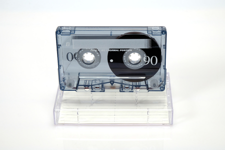 Vintage audio compact cassette. Audio cassette on a white background, front view with box. Old analog format for audio playing and recording.のeditorial素材
