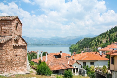 Beautiful greek landscape of mountain lake Orestiada with Kastoria roofs and old bysantine church. Greece, Kastoria.の写真素材