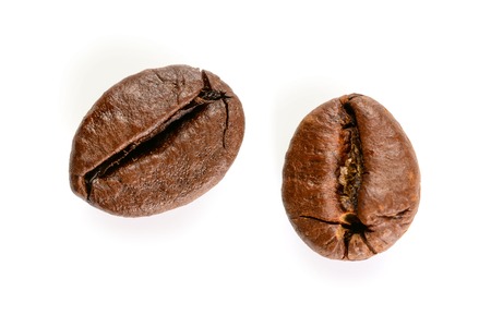 Coffee beans. Two roasted coffee bean macro view, close-up, isolated on white background.の写真素材