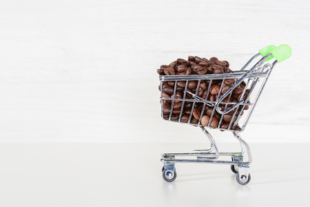 Coffee beans. Some roasted coffee beans in the mall stroller on gray background.の写真素材