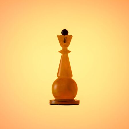 Amber chess set. Chess piece White Queen on gold gradient background.の写真素材
