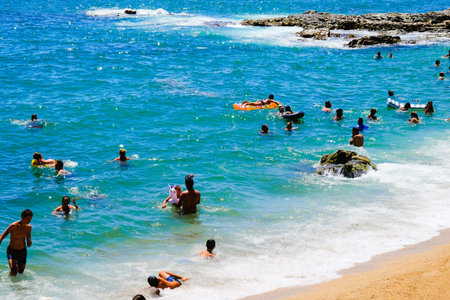 LLORET DE MAR, SPAIN - JULY 29, 2019: City beach in a hot sunny day , Costa Brava. Concept of beach...