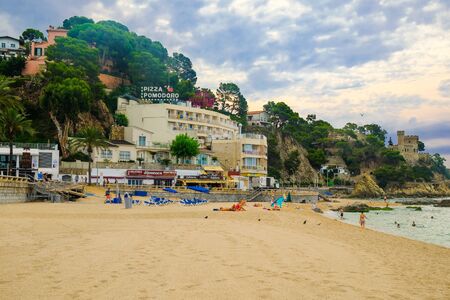LLORET DE MAR, SPAIN - JULY 29, 2019: Empty beach in bad cloudy weather in Costa Brava. Concept of the rest. Summer travel.のeditorial素材