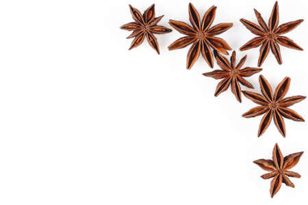 Anise star. Mockup with some star anise fruits and copy space. Close up on white background with shadows, flat lay view of chinese badiane spice or Illicium verum.の写真素材