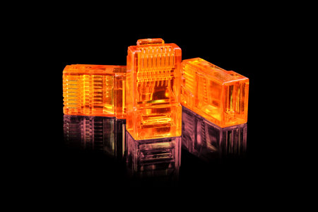 Connector rj-45. Three orange transparent connectors rj45 for network and internet. Close up macro...