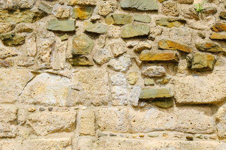 Medieval stone wall background and texture, close up.