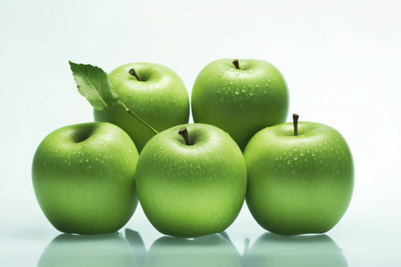 Green apples with water drops on white background. Shallow DOFの素材