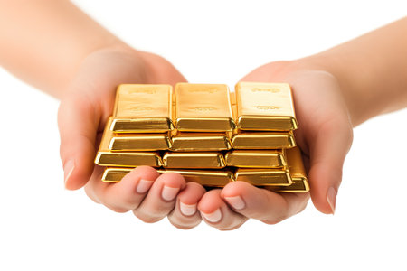 Woman's hands holding a stack of gold bars isolated on white backgroundの素材