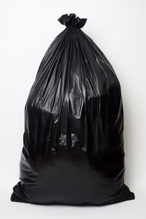 Black plastic garbage bag isolated on white background. Copy space for text.の素材