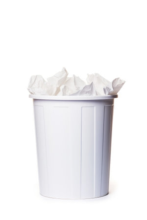 White trash can with crumpled paper isolated on white background.の素材