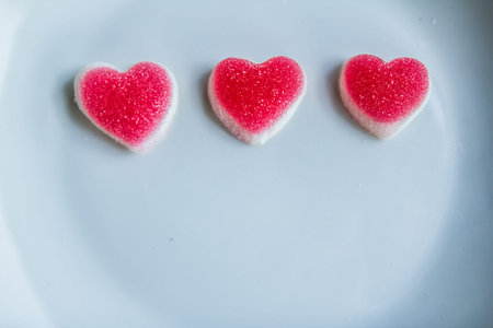 Three red hearts on a white plate.