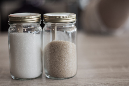 White sugar and brown sugar in a small glass Bottle In the coffee shop.の写真素材