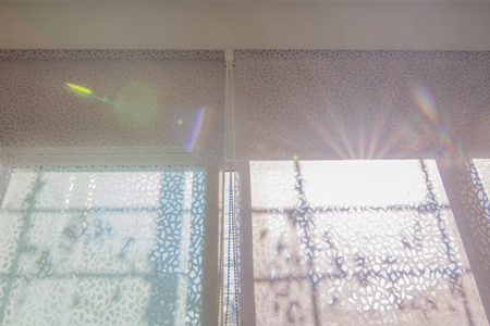 Blurred photo of Curtain or roller blind protected sunlight in my home In the morning the sun shines.の写真素材