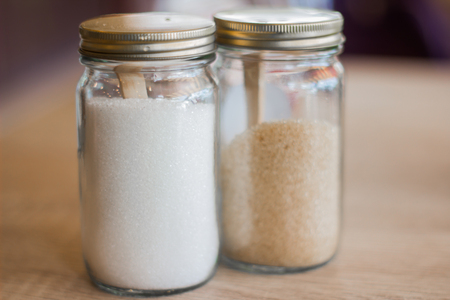 White sugar and brown sugar in a small glass Bottle In the coffee shop.の写真素材