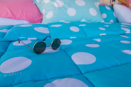 Sunglasses on blue blankets.の写真素材