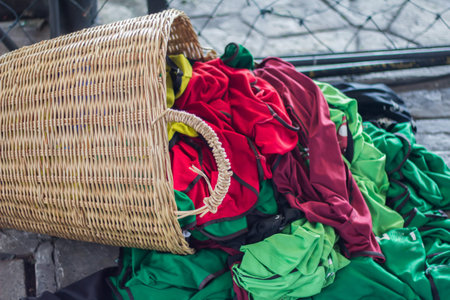 Rattan basket with bright color used clothes.