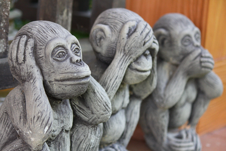 Three monkey,close up of hand small statues with the concept of see no evil, hear no evil and speak no evil.の写真素材