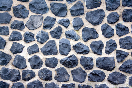 Harbour wall in Amsterdam, all made of cobble stones.の写真素材