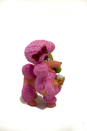 Plastic pink toy poodle on isolated whiteの写真素材