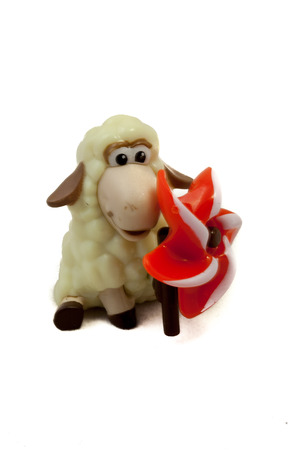 Plastic off-white toy sheep on isolated whiteの写真素材