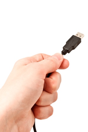 Closeup of hand holding USB cable. Isolated on white backgroundの写真素材