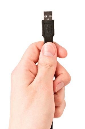 Closeup of hand holding USB cable. Isolated on white backgroundの写真素材